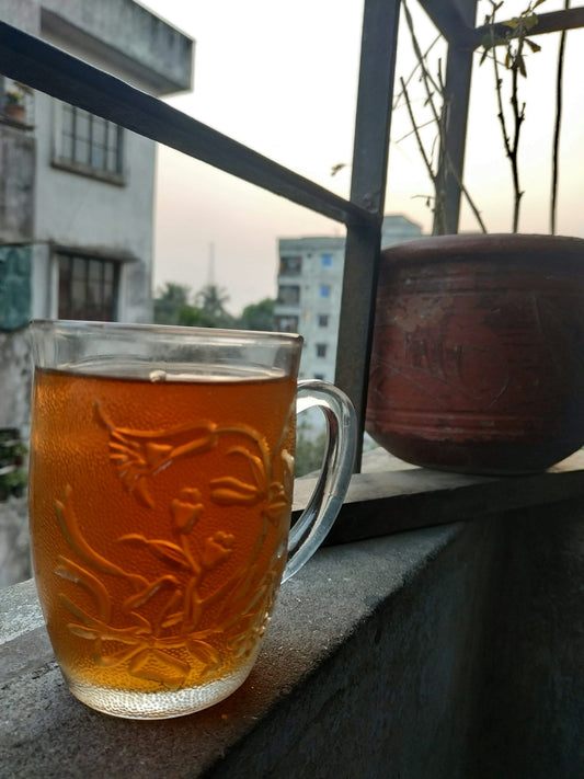 a cup of tea sitting on top of a window sill