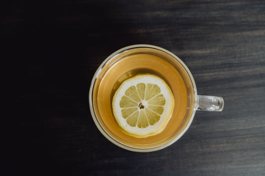 a cup of tea with a lemon slice in it