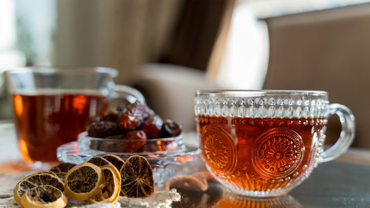 Two cups of tea with dates and dried lemons
