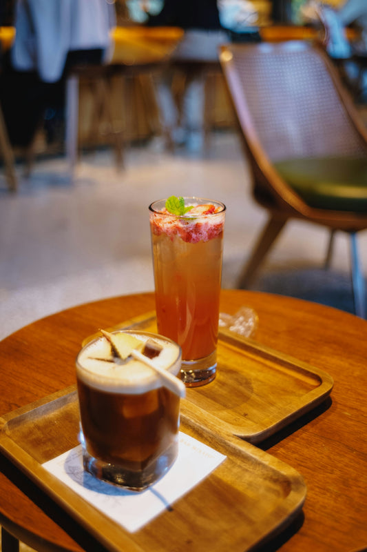Two refreshing drinks on wooden trays
